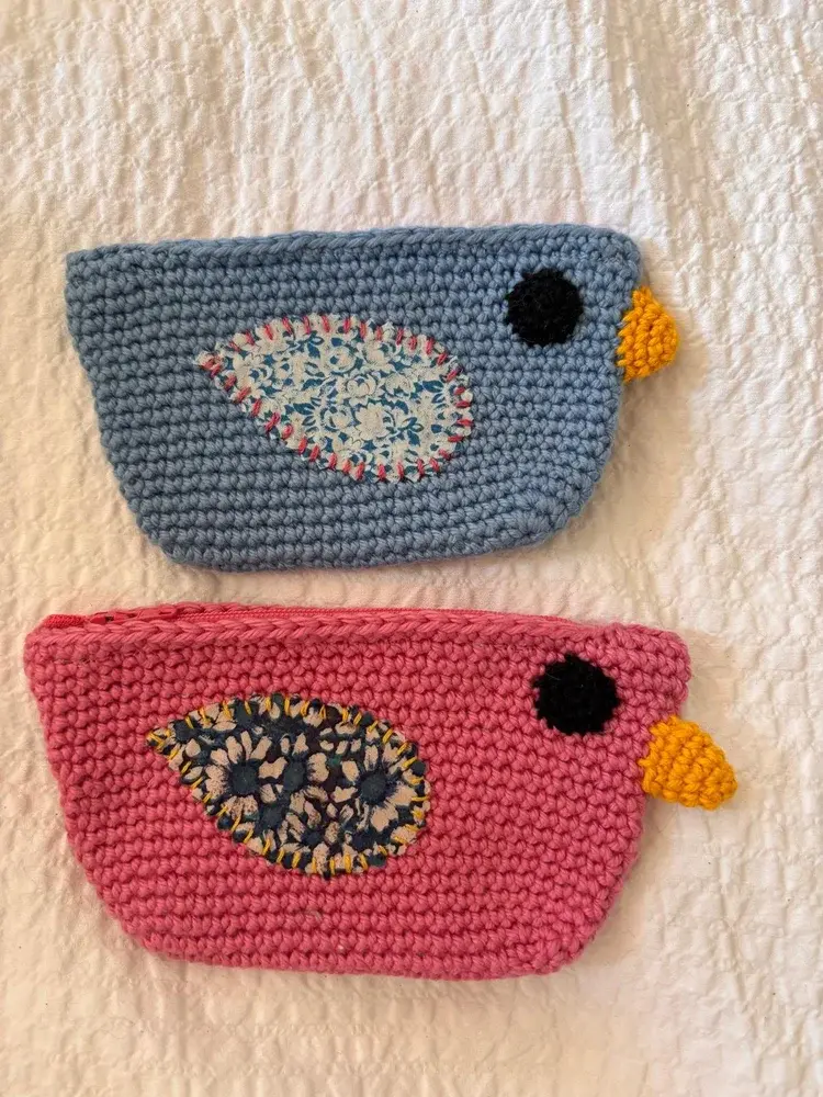 Crochet bird-shaped coin purses in blue and pink