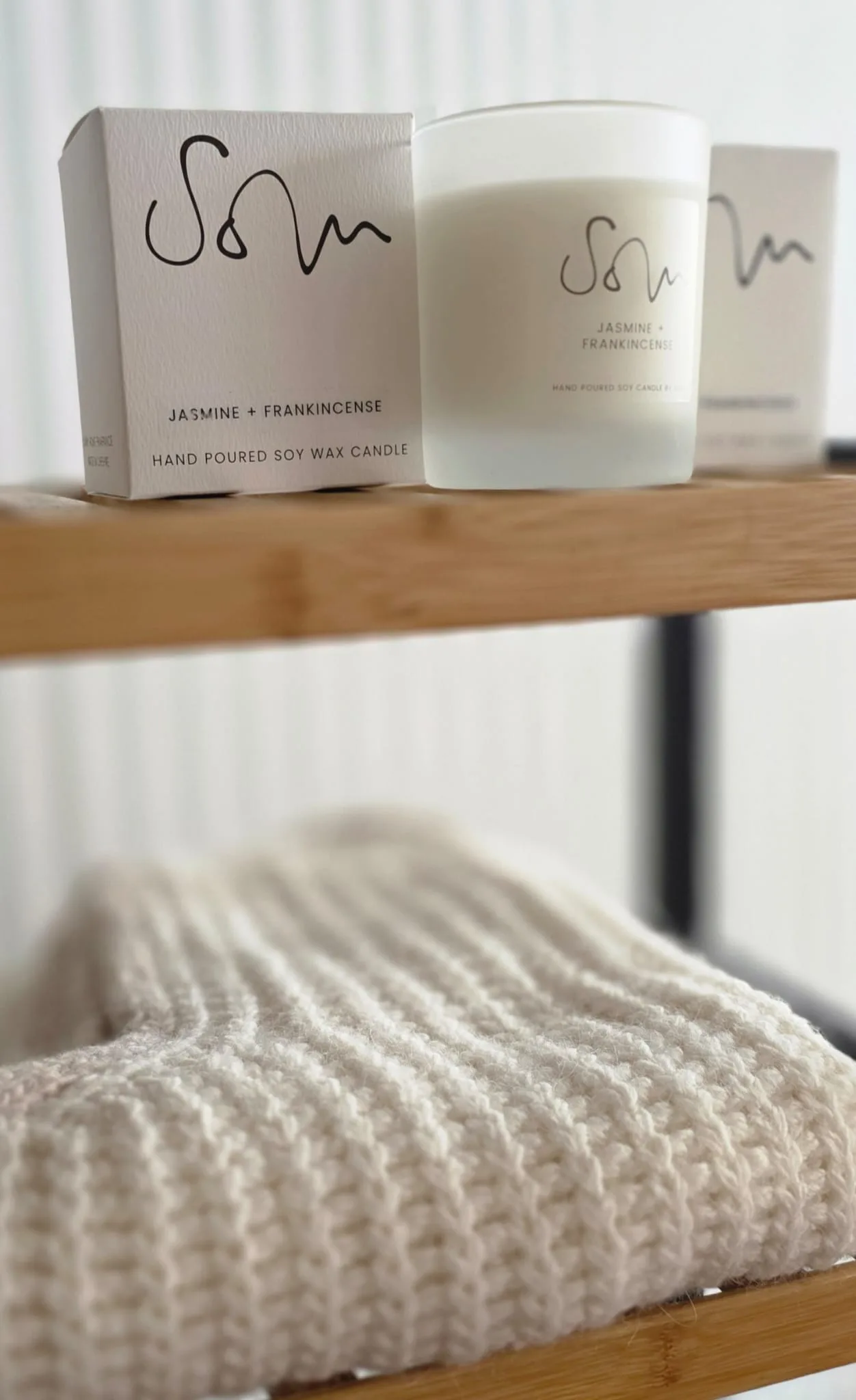 Handmade candles and cloth on a shop shelf